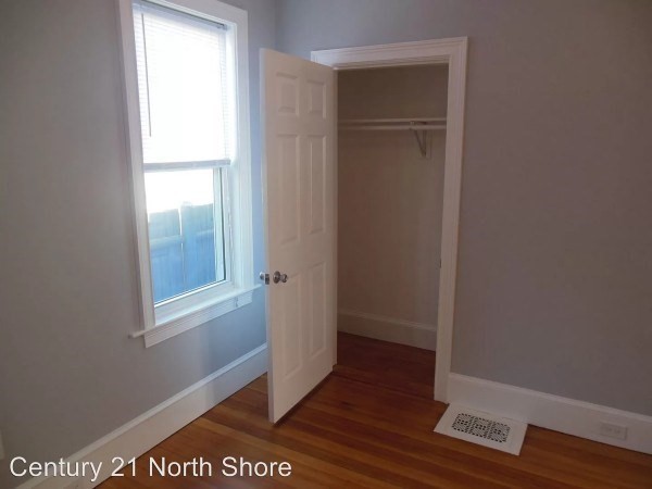 5 Pearl Street, Unit 1 Salem, MA 01970 - Photo 13 of 14 a view of an empty room with wooden floor and closet