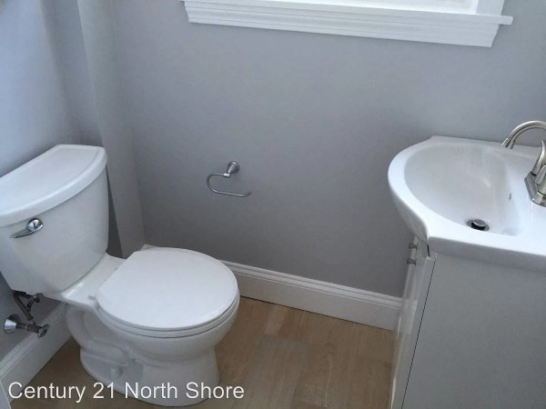 5 Pearl Street, Unit 1 Salem, MA 01970 - Photo 10 of 14 a white toilet sitting next to a bathroom sink