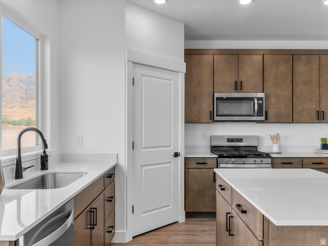 1380 West 2350 South, Unit 16 Perry, UT 84302 - Photo 18 of 34 Kitchen featuring wood-finish cabinetry, stainless steel appliances, white countertops, and recessed lighting