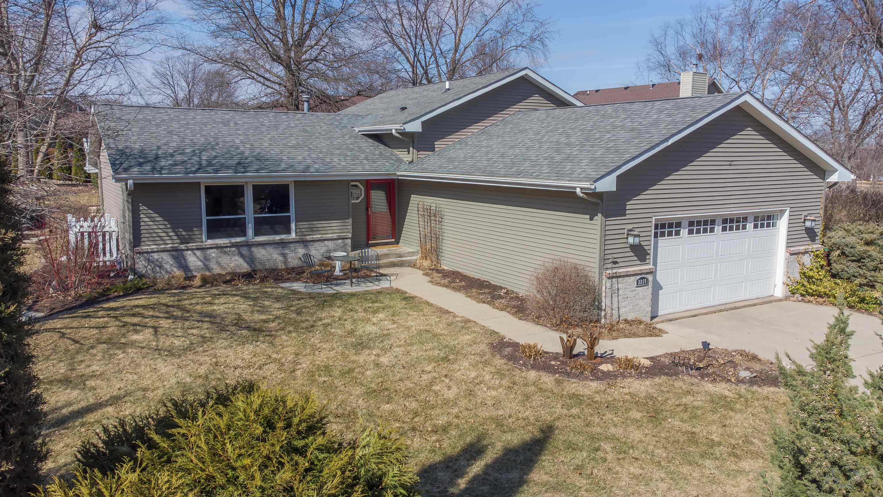 a view of house with backyard and trees