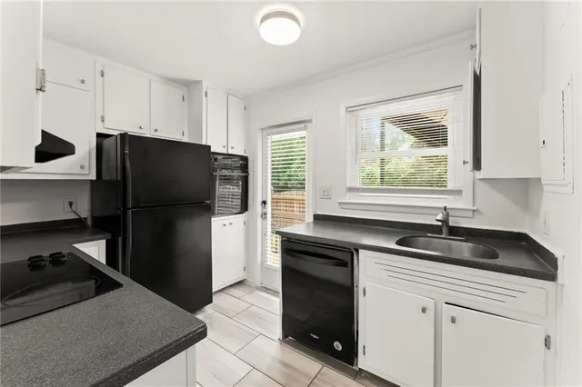 a kitchen with a refrigerator and a sink