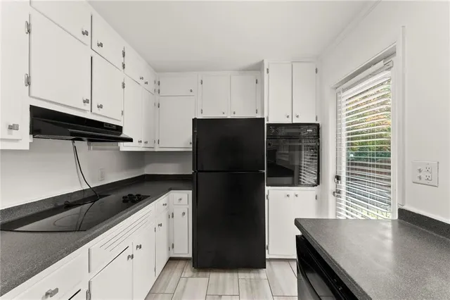 a kitchen with a refrigerator and a stove
