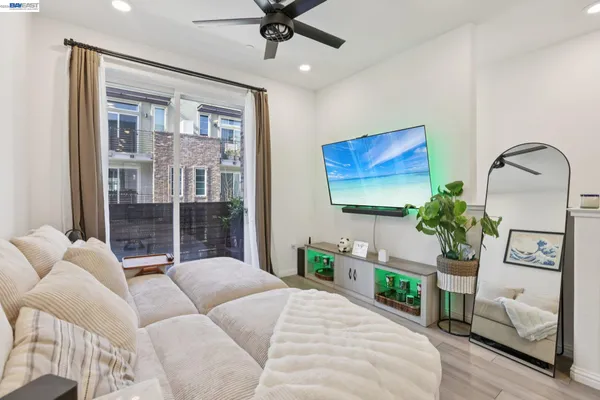 a living room with furniture a chandelier and a window