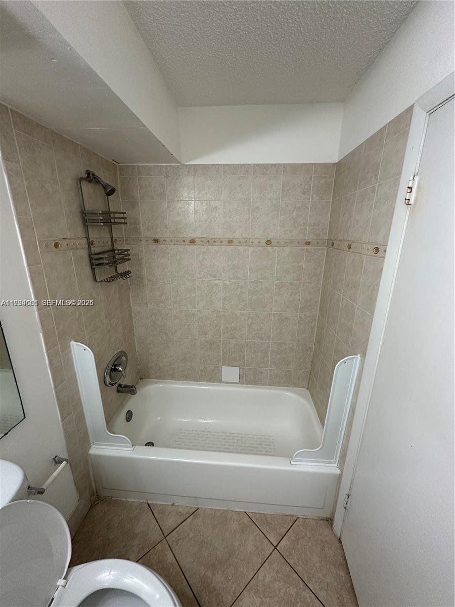 951 Lyons Road, Unit 6103 Coconut Creek, FL 33063 - Photo 5 of 5 a bathroom with a bathtub and toilet