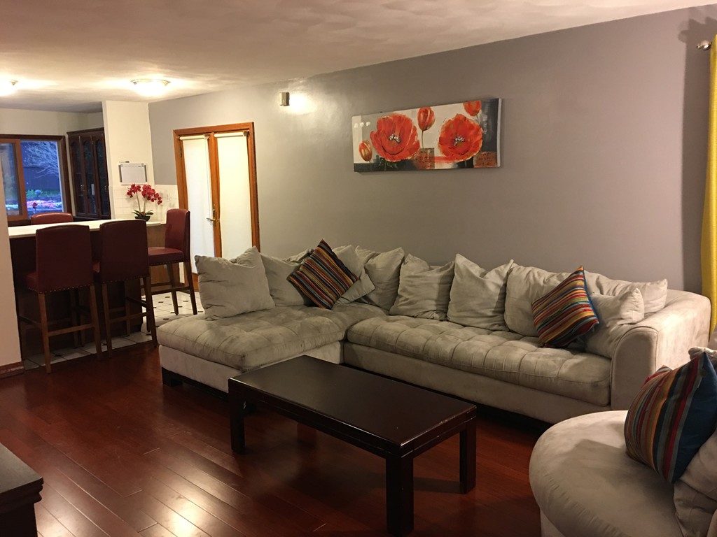 197 Acropolis Road Lowell, MA 01854 - Photo 17 of 29 a living room with furniture kitchen view and a wooden floor