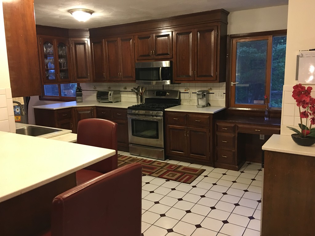197 Acropolis Road Lowell, MA 01854 - Photo 18 of 29 a kitchen with a sink and a stove top oven