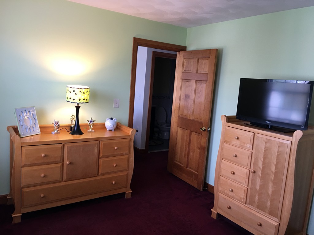 197 Acropolis Road Lowell, MA 01854 - Photo 20 of 29 a room with cabinets and flat screen tv