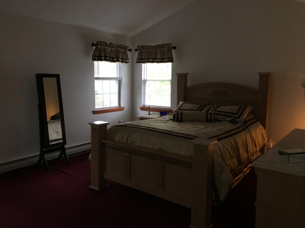 197 Acropolis Road Lowell, MA 01854 - Photo 21 of 29 a bedroom with a bed and wooden floor