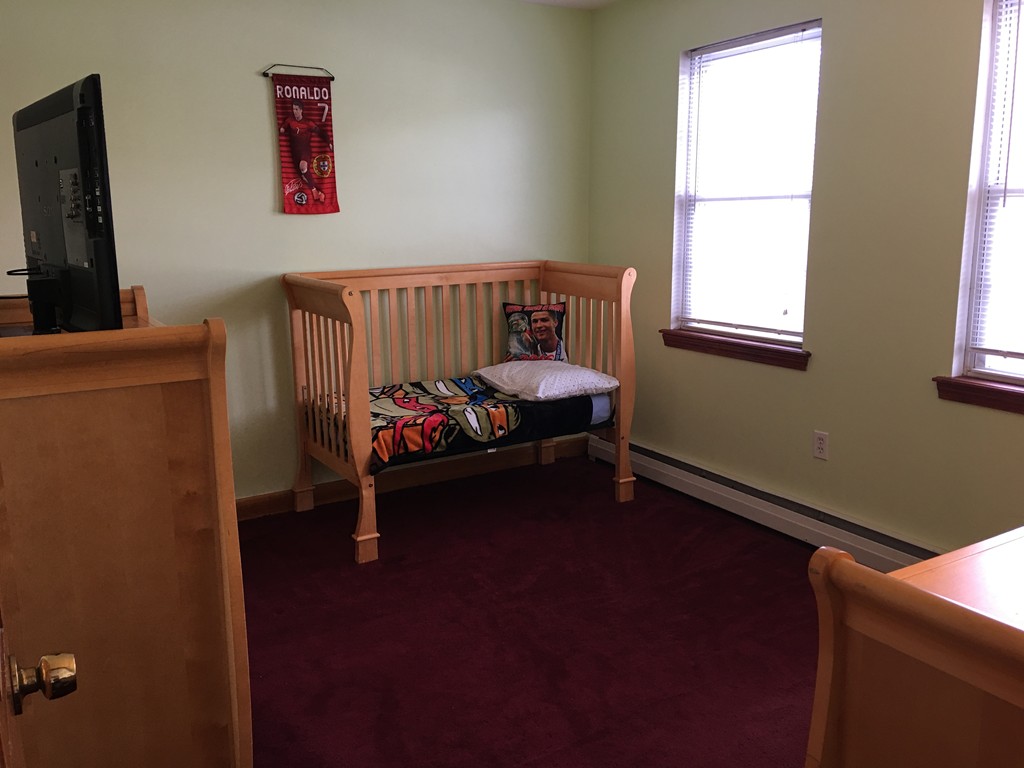 197 Acropolis Road Lowell, MA 01854 - Photo 23 of 29 a bedroom with a bed and a window