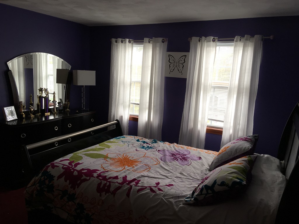 197 Acropolis Road Lowell, MA 01854 - Photo 26 of 29 a bedroom with a bed mirror and window