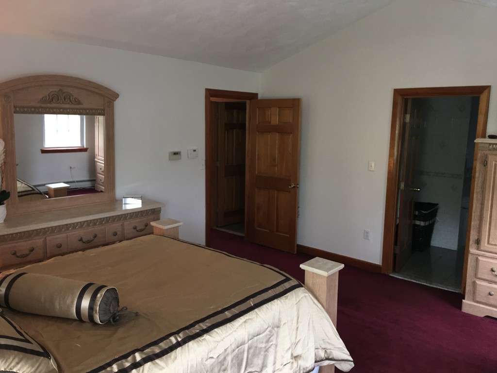 197 Acropolis Road Lowell, MA 01854 - Photo 27 of 29 a bedroom with a bed and wooden floor