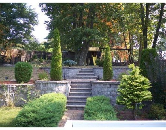 197 Acropolis Road Lowell, MA 01854 - Photo 4 of 29 a view of a garden with plants