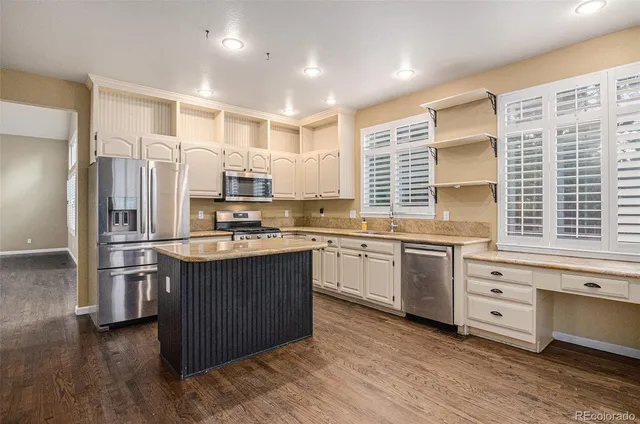 a kitchen with stainless steel appliances granite countertop a stove and a refrigerator