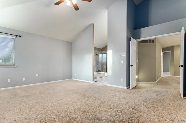a bathroom with a tub sink shower and mirror