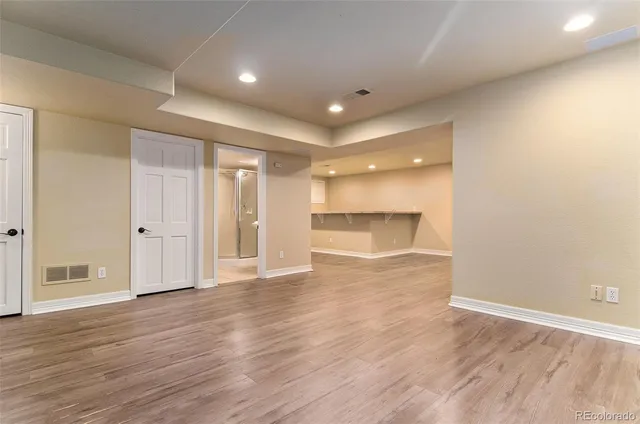 an empty room with wooden floor