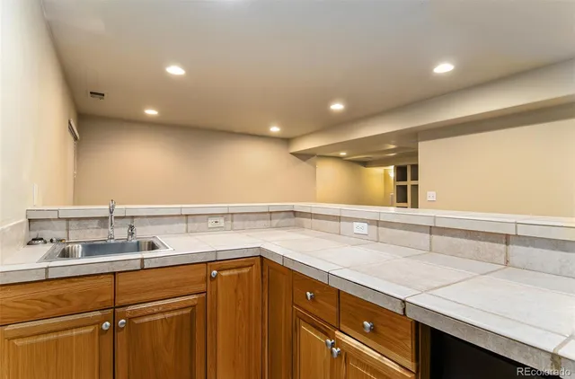 a bathroom with a shower a mirror and a sink