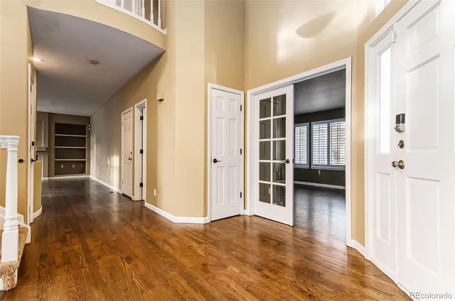an empty room with wooden floor and closet