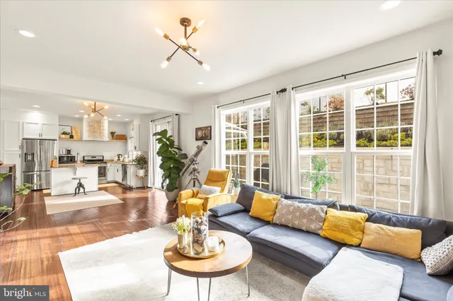 a view of a kitchen with a sink a fireplace and wooden floor