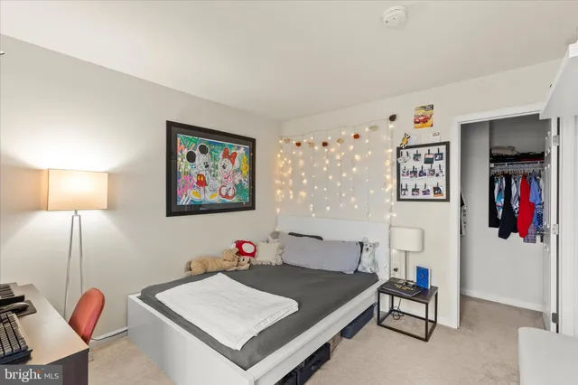 a bedroom with a bed table and a potted plant