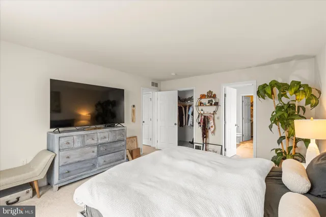 a living room with furniture a window and gym equipment