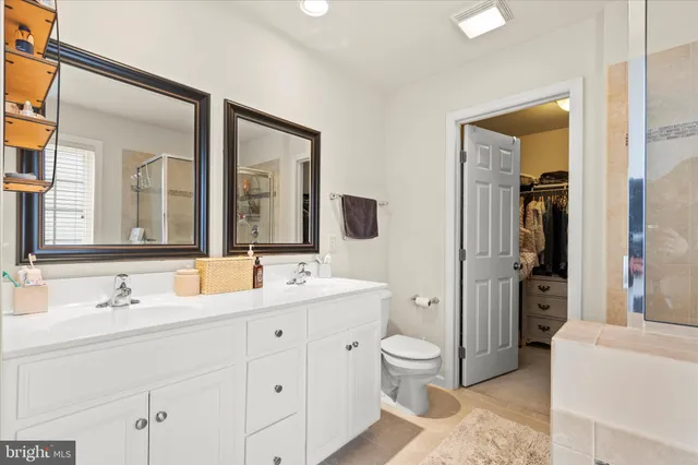 a living room with furniture a wooden floor and next to a window