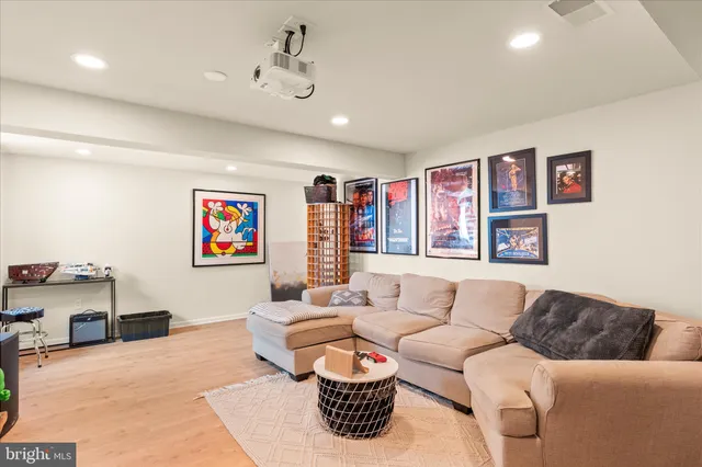 a room with furniture a bookshelf and a window