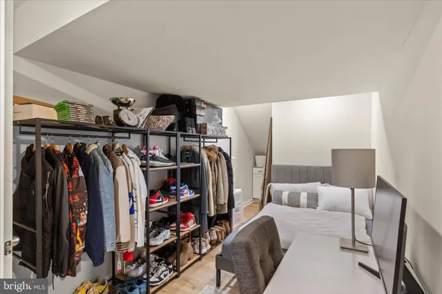 a bathroom with a sink a toilet a mirror and a shower