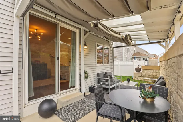 a view of a house with a barbeque and wooden stairs