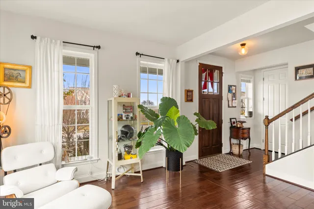 a view of a livingroom with furniture window and wooden floor