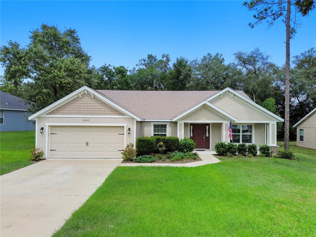 6303 Southwest 116th St Road Ocala, FL 34476 - Photo 1 of 1 a front view of house with yard and green space