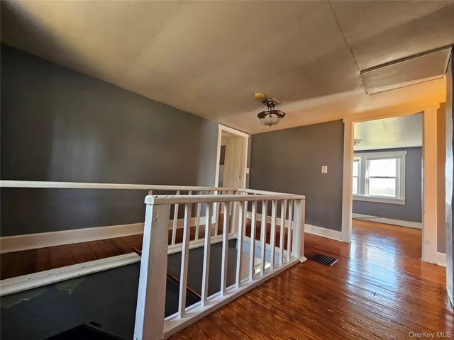a view of hallway with wooden floor