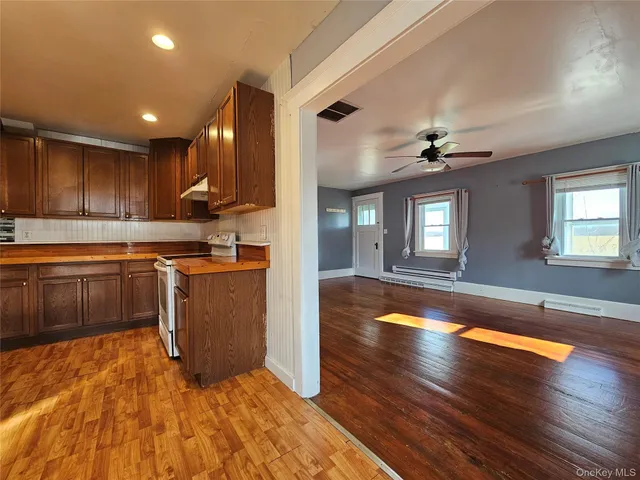 a kitchen with wooden floors and cabinets
