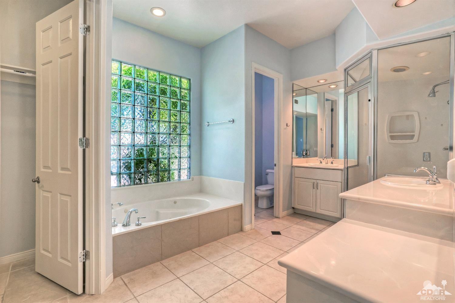 52 Sherwood Road Rancho Mirage, CA 92270 - Photo 15 of 25 a bathroom with a tub a sink and a large mirror