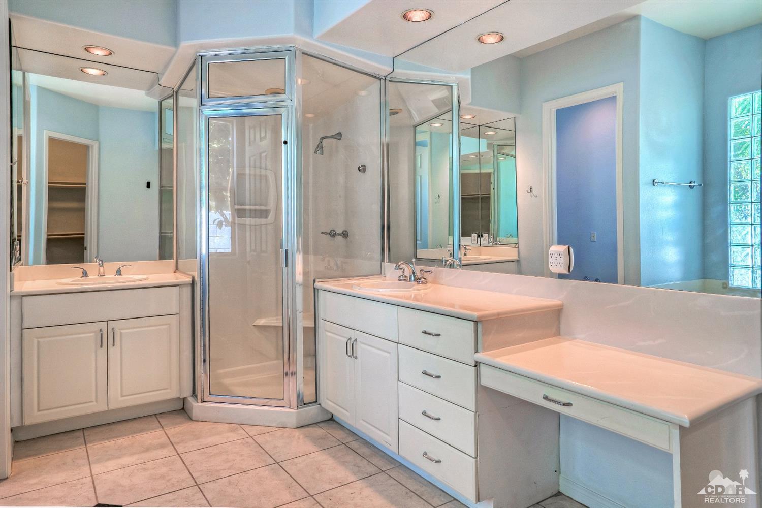 52 Sherwood Road Rancho Mirage, CA 92270 - Photo 16 of 25 a spacious bathroom with a shower sink and mirror