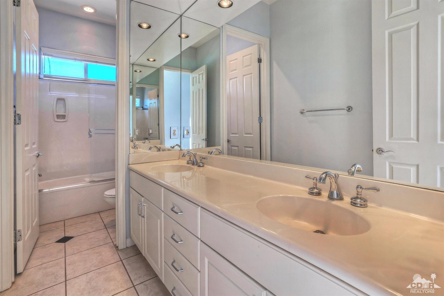 52 Sherwood Road Rancho Mirage, CA 92270 - Photo 18 of 25 a bathroom with a sink double vanity granite tub shower and a mirror