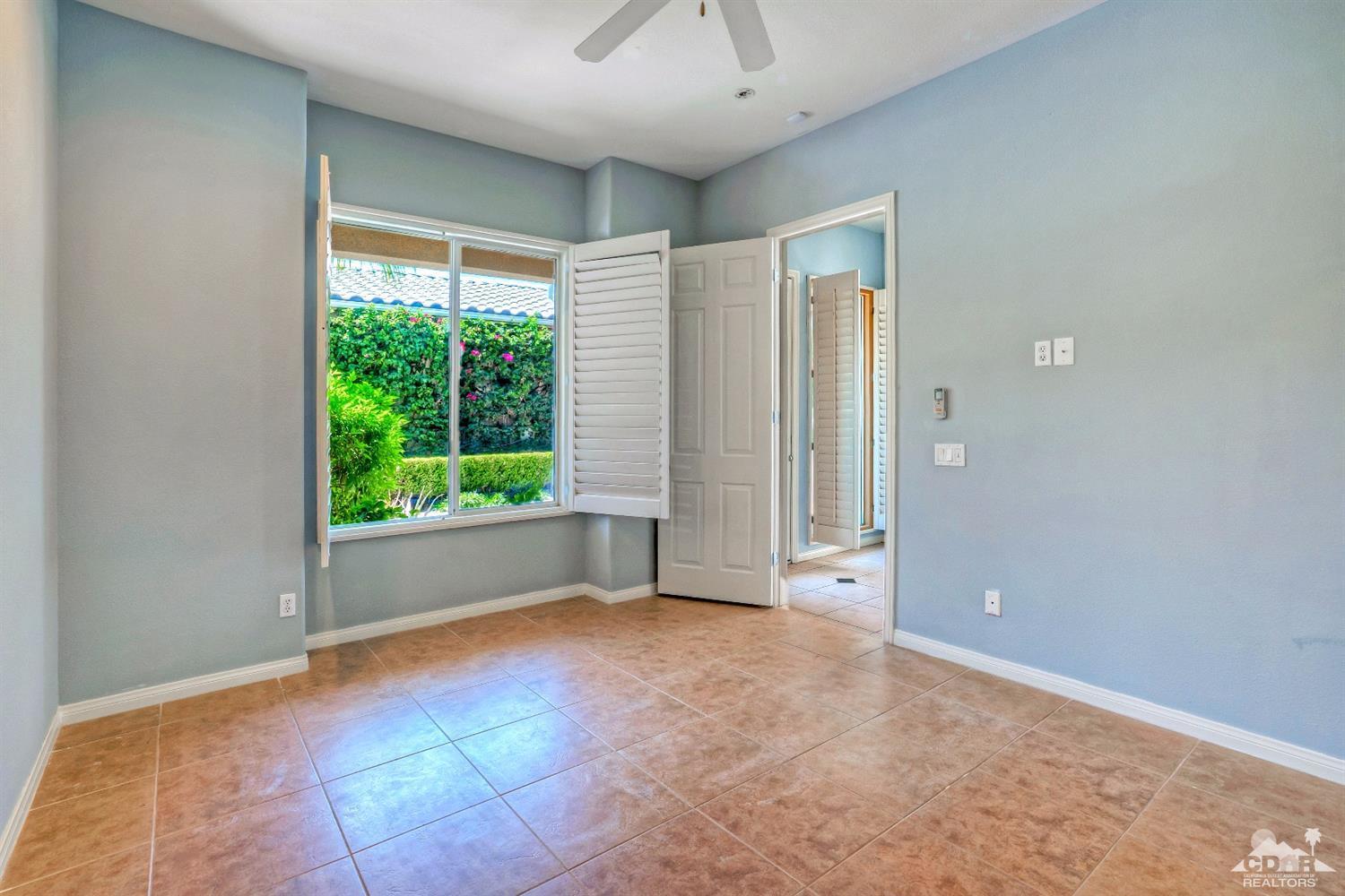 52 Sherwood Road Rancho Mirage, CA 92270 - Photo 21 of 25 a view of empty room with window and ceiling fan