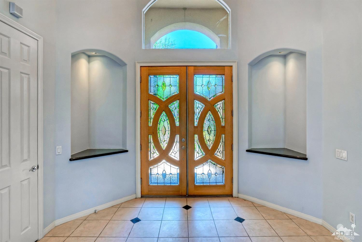 52 Sherwood Road Rancho Mirage, CA 92270 - Photo 3 of 25 an empty room with windows and fan