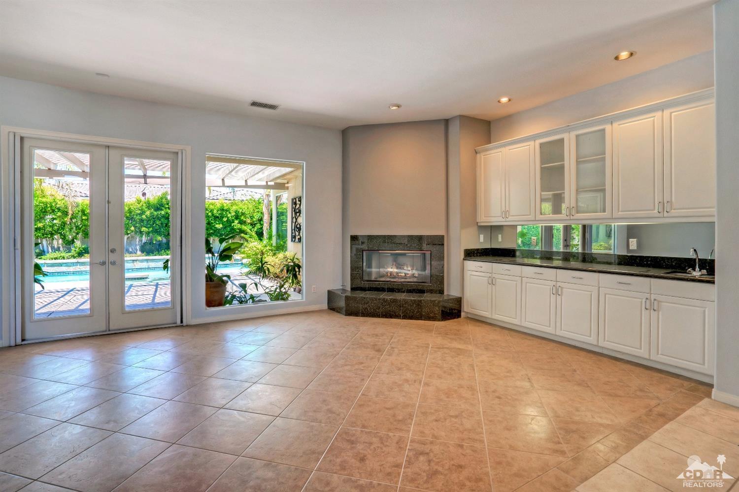 52 Sherwood Road Rancho Mirage, CA 92270 - Photo 8 of 25 a open kitchen with granite countertop a stove a sink and a microwave