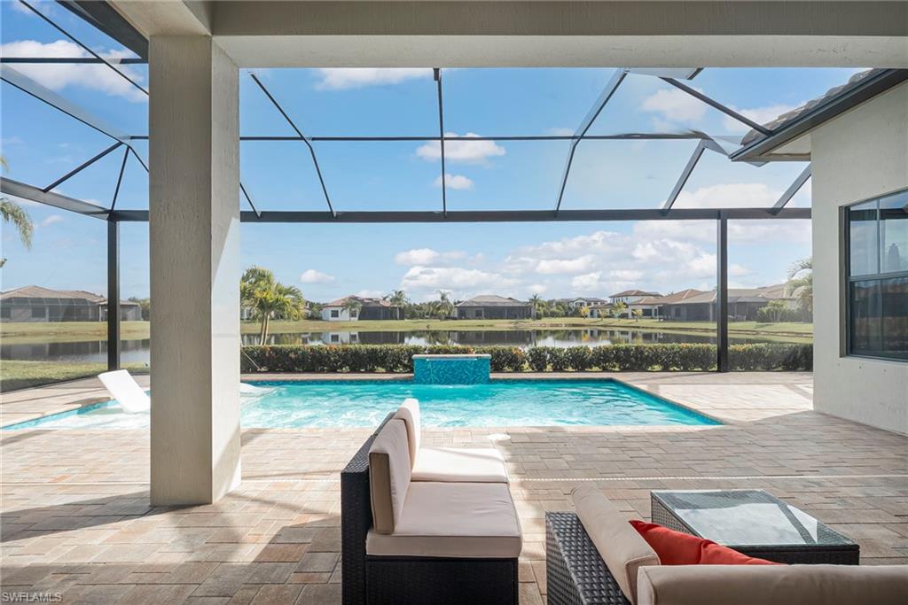 5344 Allen Place Ave Maria, FL 34142 - Photo 2 of 43 Swimming pool with a covered porch area, uncovered patio area, picture window lanai overlooking water view
