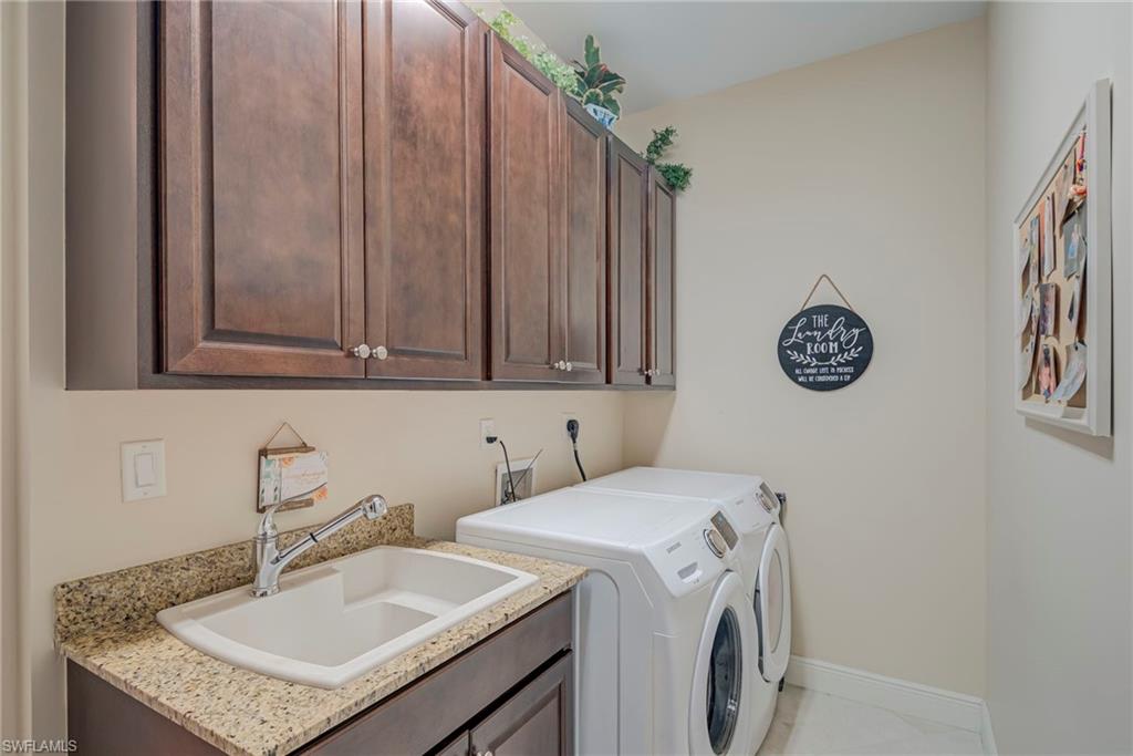 5344 Allen Place Ave Maria, FL 34142 - Photo 22 of 43 Laundry area with washer and dryer and cabinet space