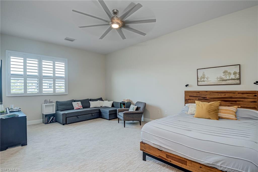 5344 Allen Place Ave Maria, FL 34142 - Photo 23 of 43 En Suite Oversized 2nd Floor Loft Bedroom #5 carpeted featuring a ceiling fan