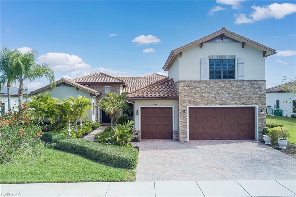 5344 Allen Place Ave Maria, FL 34142 - Photo 31 of 43 Mediterranean / spanish house with a front yard, paver driveway, stucco siding, and stone siding
