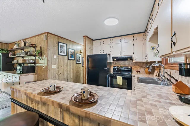 a kitchen with a refrigerator stove and sink