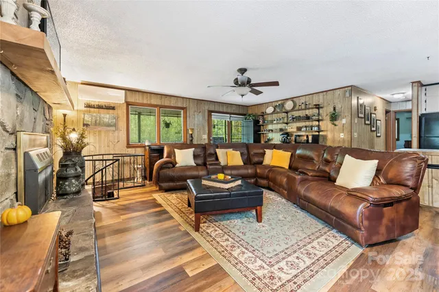 a living room with fireplace furniture and a wooden floor