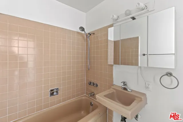 a bathroom with a sink shower and a bathtub
