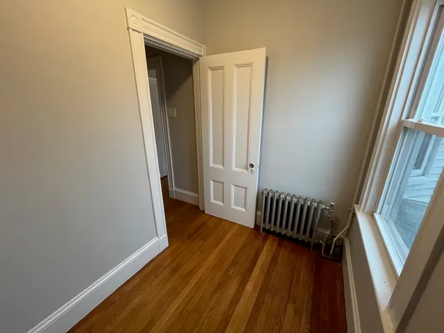 a view of hallway with wooden floor