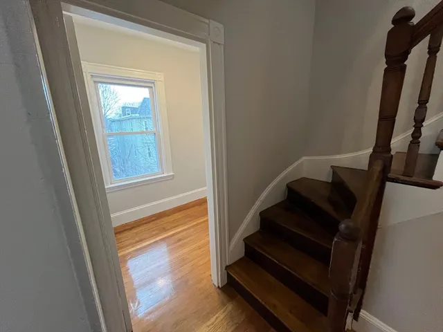 a view of entryway with wooden floor and stairs