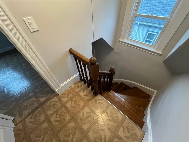 a view of a workspace with furniture and wooden floor
