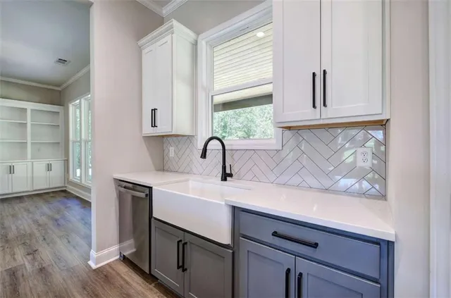 a view of cabinets a sink and a window in a room