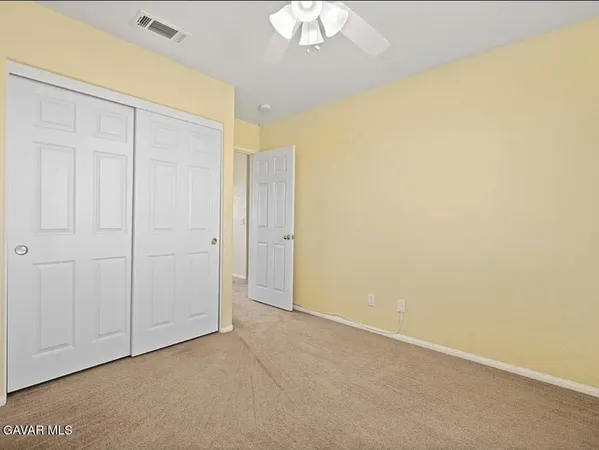 an empty room with a ceiling fan